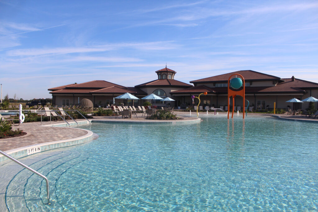 View of Addison Village Club's outdoor pool and clubhouse.
